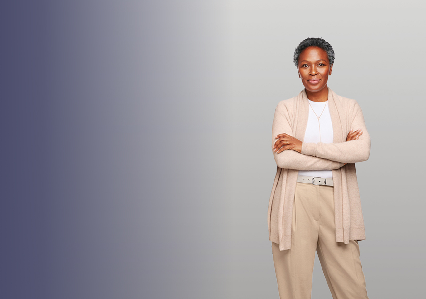 Woman with arms crossed looking into camera.